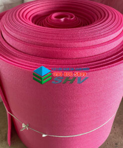 Cuộn xốp màu hồng đậm được quấn chặt, có logo và số điện thoại in trên bề mặt, đặt trên sàn xi măng.