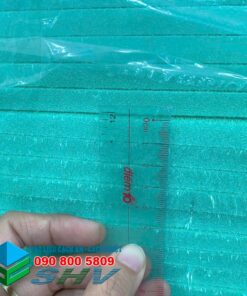 Tấm xốp XPS 10mm màu xanh ngọc, có bề mặt rãnh, được đo bằng thước kẻ.